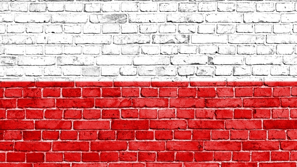 Brick wall painted in colours of Polish flag