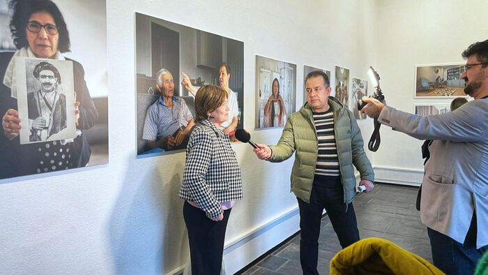Woman being interviewed in art exhibition