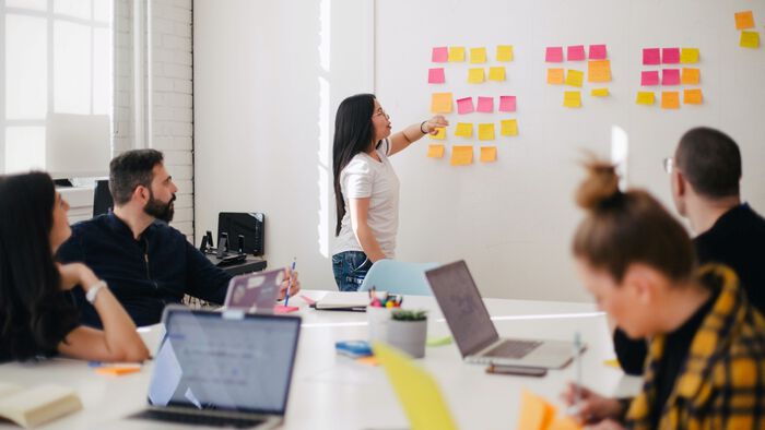 People in meeting looking at whiteboard